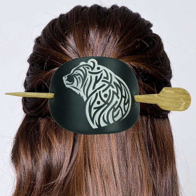 Hair tie with bear design and wooden ends on a person's hair against a white background