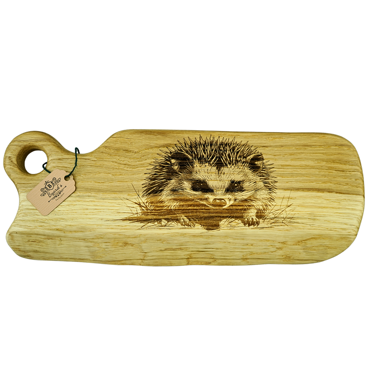 Wooden cutting board with a hedgehog engraving on a white background