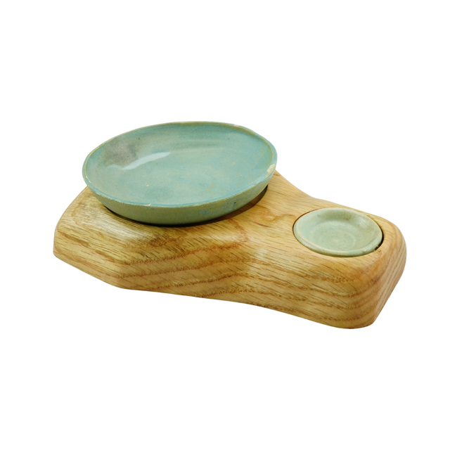 Ceramic bowls on a wooden stand with a white background