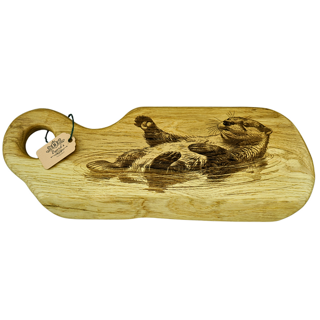 Wooden cutting board with engraved design of otter on a white background