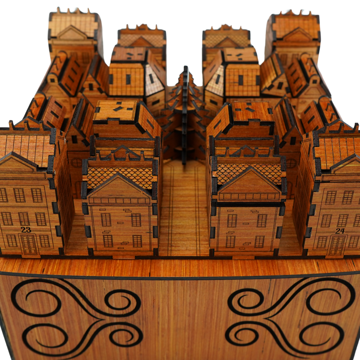 Front view of the cherry wood Christmas Advent Village, with numbered houses, a central tree and decorative storage box beneath.