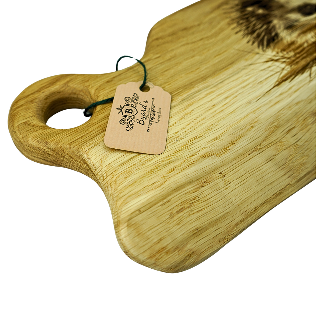 Wooden cutting board with a branded tag on a white background