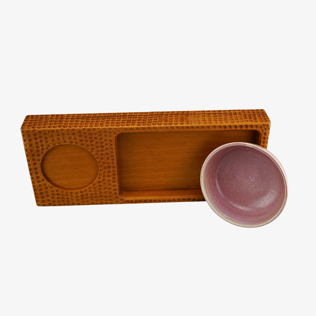 Brown wooden tray with a pink ceramic bowl on a white background