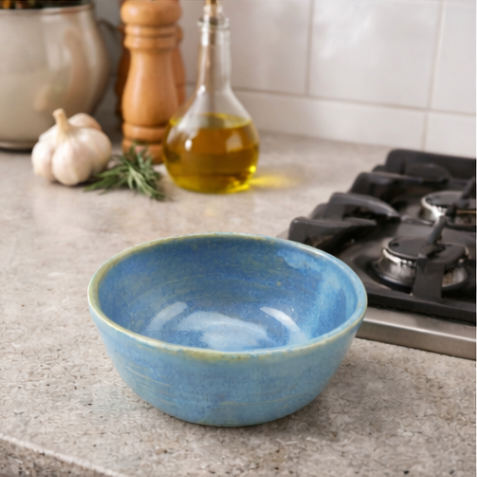 blue ceramic bowls in various settings including a kitchen.