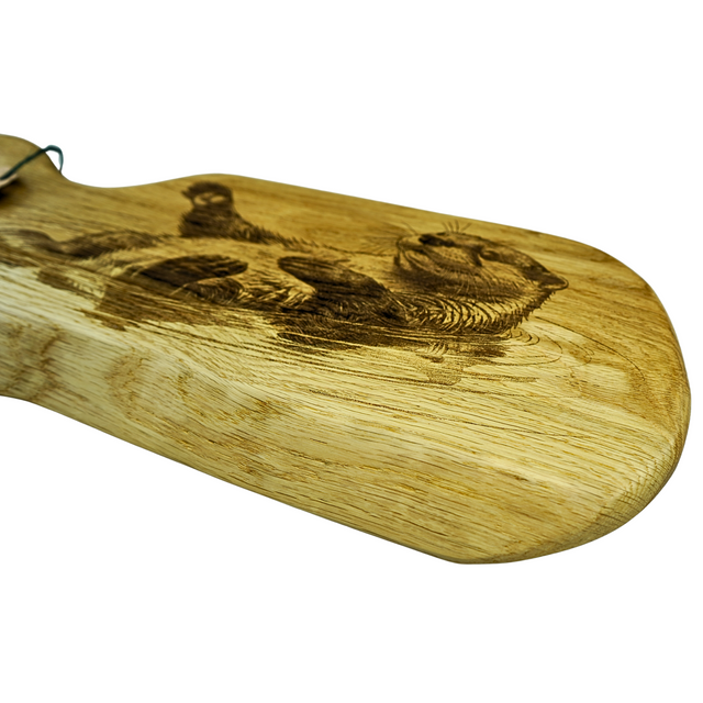 Wooden cutting board with engraved design on a white background