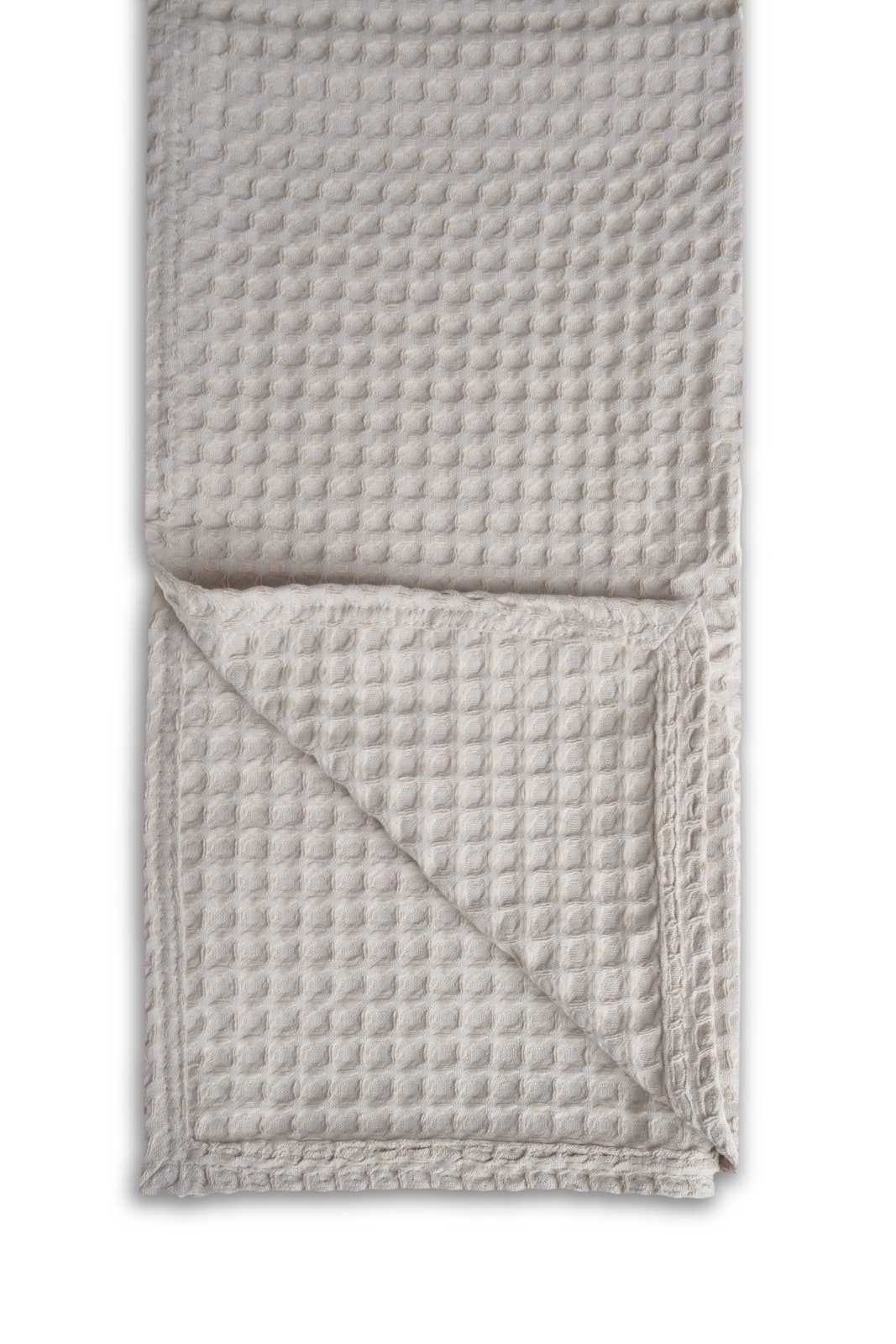 Woven textured blanket on a white background