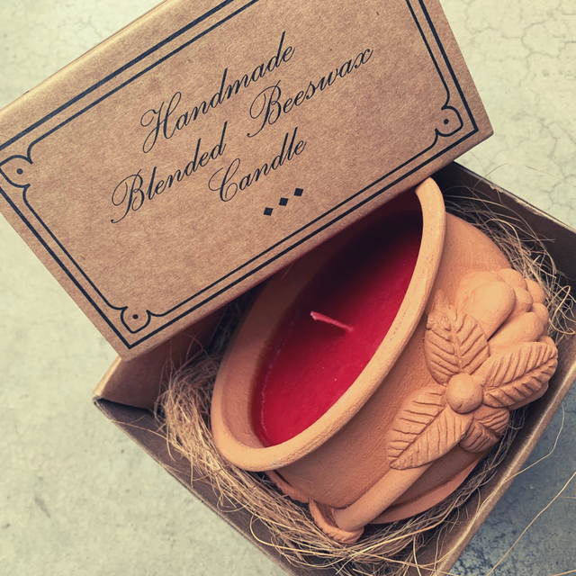 Handmade blended beeswax candle in a cardboard box with decorative text.