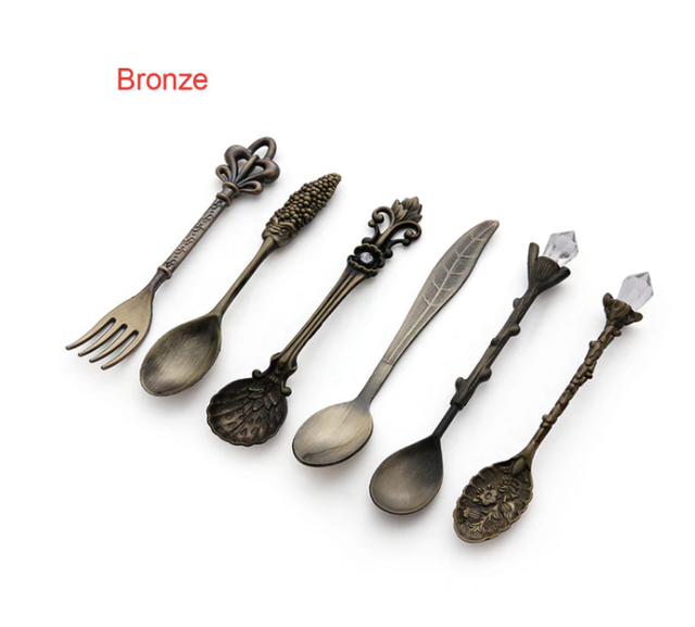 Set of bronze spoons and a fork on a white background with 'Bronze' label.
