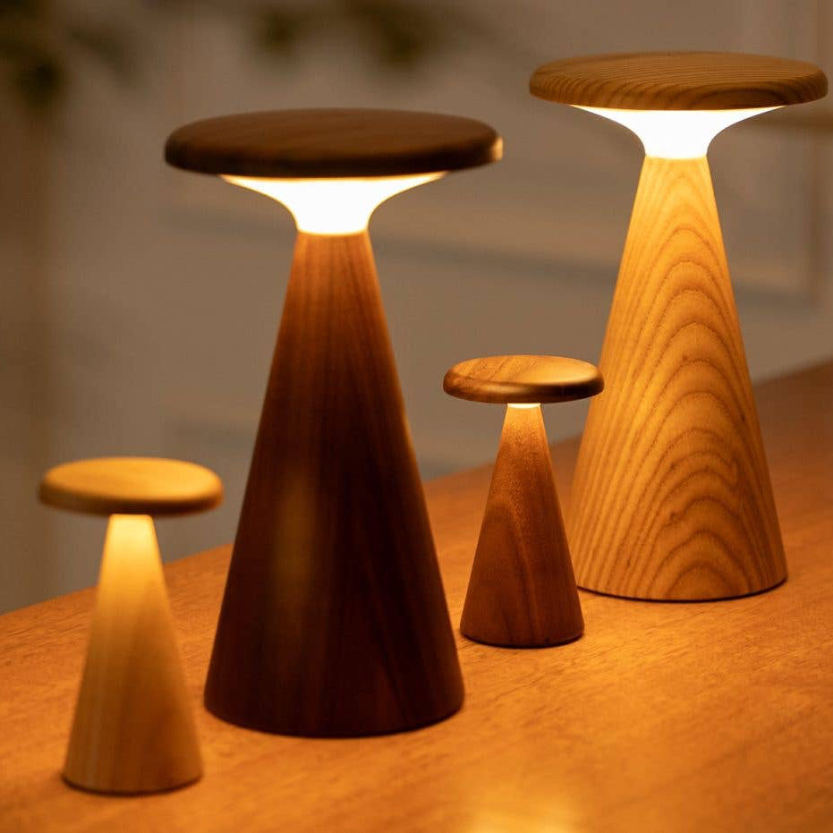 Set of wooden stools with built-in lights on a wooden surface.