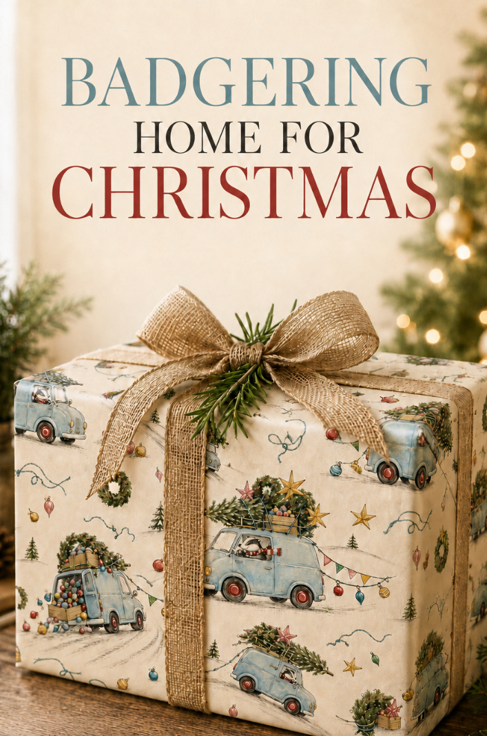 A Christmas-themed gift box wrapped in cream-colored paper with a vintage camper pattern, tied with a burlap ribbon and bow, sitting on a wooden table with festive background elements and the text 'BADGERING HOME FOR CHRISTMAS' at the top.