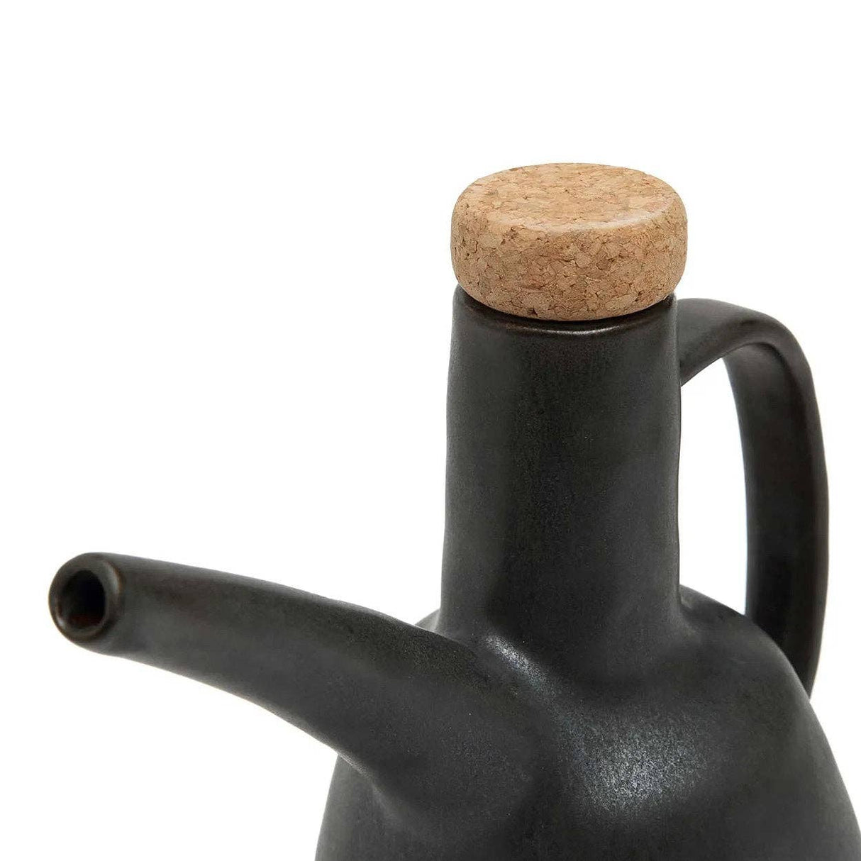 Black ceramic oil dispenser with a cork lid on a white background