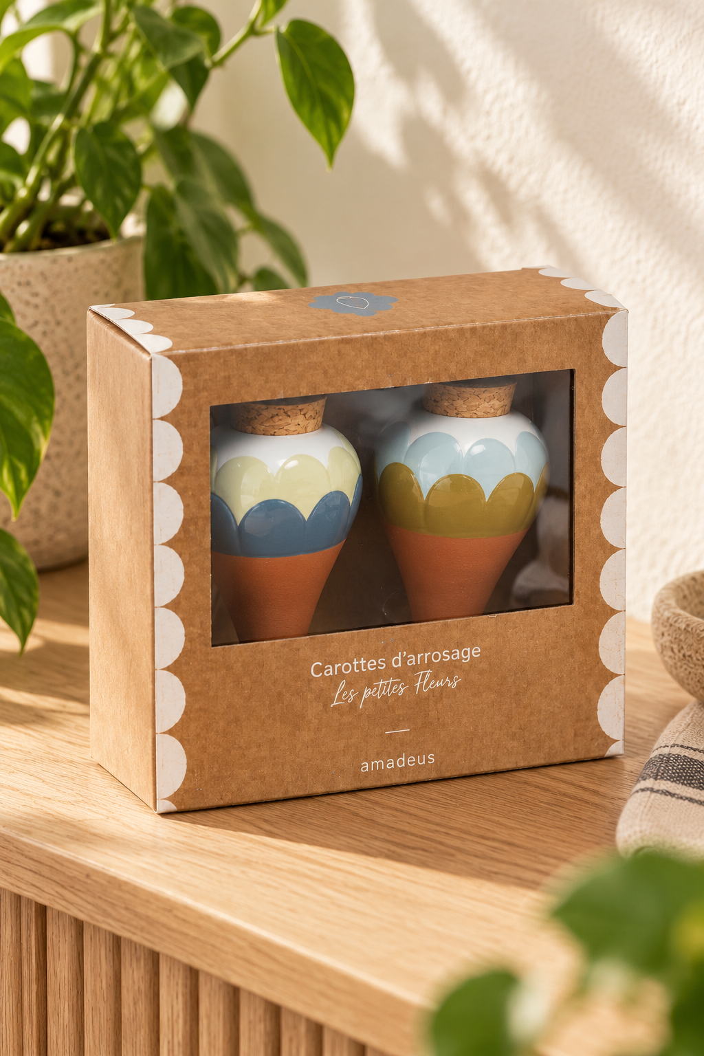 Set of two ceramic watering spikes for potted plants. Ana Blue includes complementary scalloped designs in blue, pale cream and olive, with white tops, terracotta-coloured tapered points and cork stoppers. Presented together in a windowed cardboard box