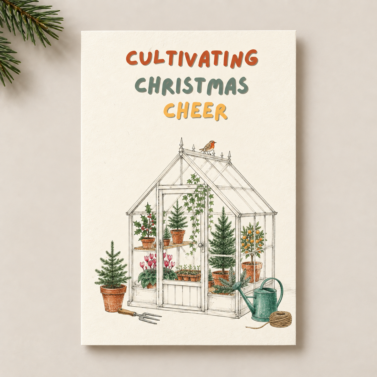 A vertical greeting card with the text 'CULTIVATING CHRISTMAS CHEER' above a hand-drawn greenhouse illustration with potted plants, a bird on the roof, and gardening tools. The card is photographed against a light neutral background with a pine branch entering from the top left.