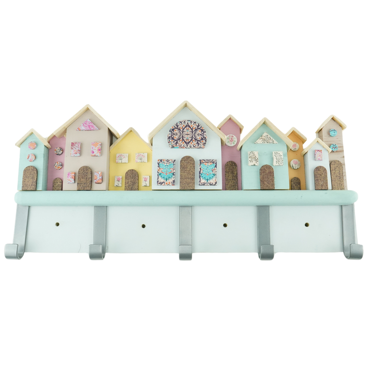 A handcrafted coat hook rack with a row of colorful houses featuring decoupage windows and doors, mounted on a wall.
