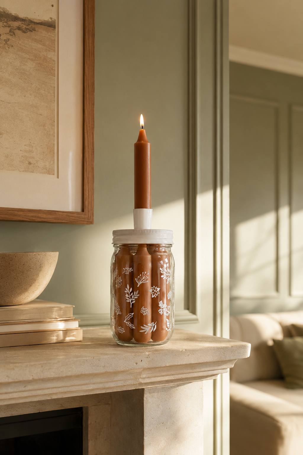 Decorative glass candle storage jar with white botanical motifs, five brown dinner candles and one candle displayed in the holder on the lid in a sunlit interior.