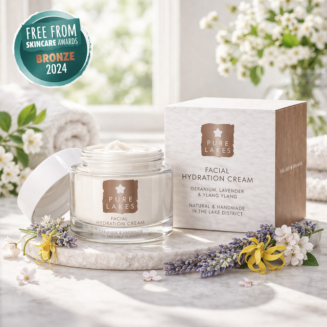 Pure Lakes facial hydration cream jar and box on a marble surface with flowers and 'Free from Skincare Awards Bronze 2024' badge.