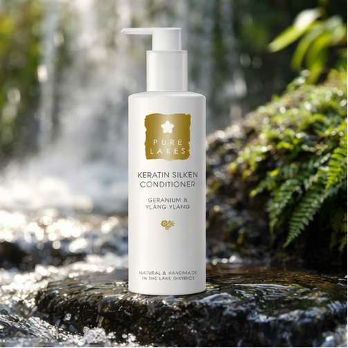 Geranium & Ylang Ylang Keratin Silken Conditioner on rock with plants and running water