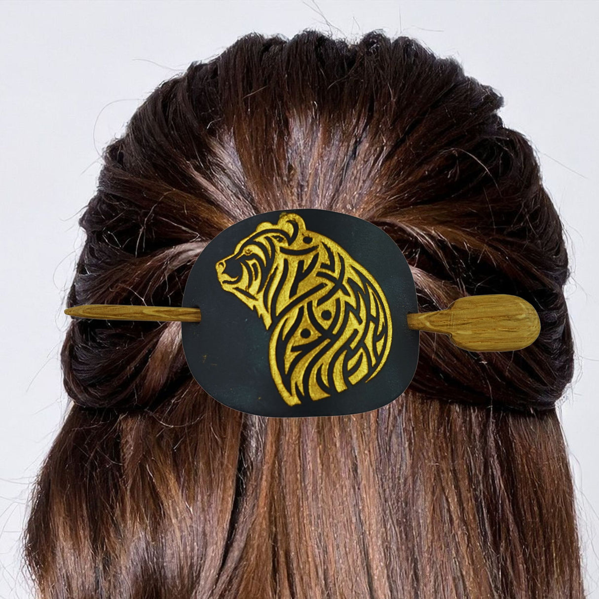 Hair bun with a decorative hair clip featuring a tiger design on a white background