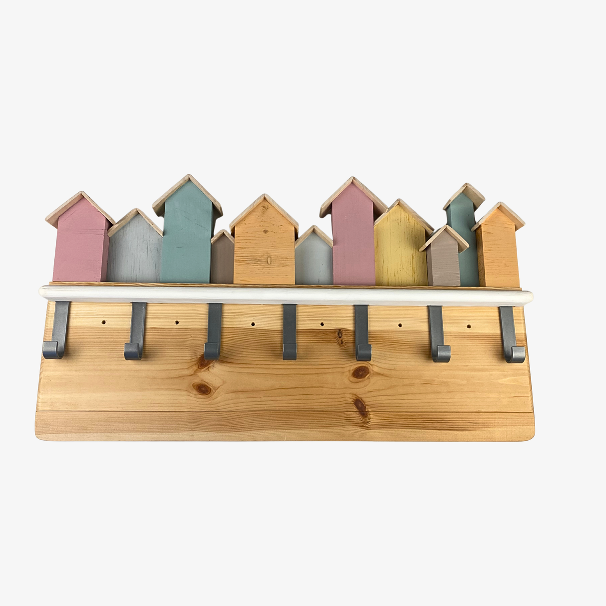 Wooden shelf with colorful beach hut design on a white background