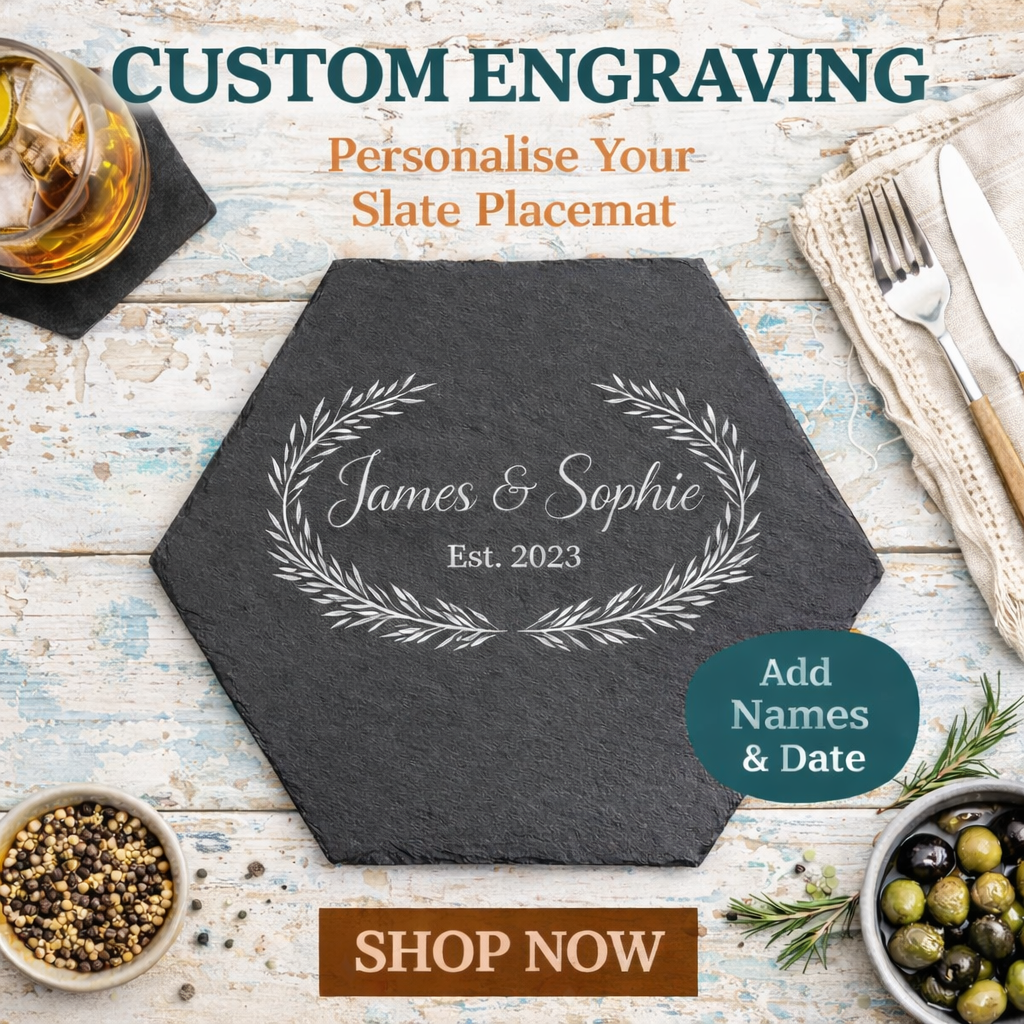 Hexagonal slate placemat with engraved names and date on a rustic wooden table with dining items.