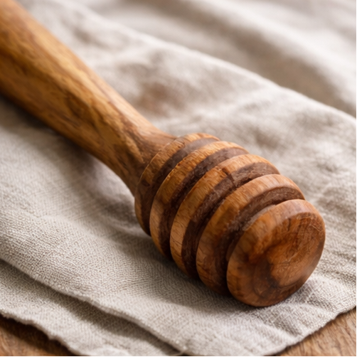 Collage of wooden honey dipper in various settings with honey.