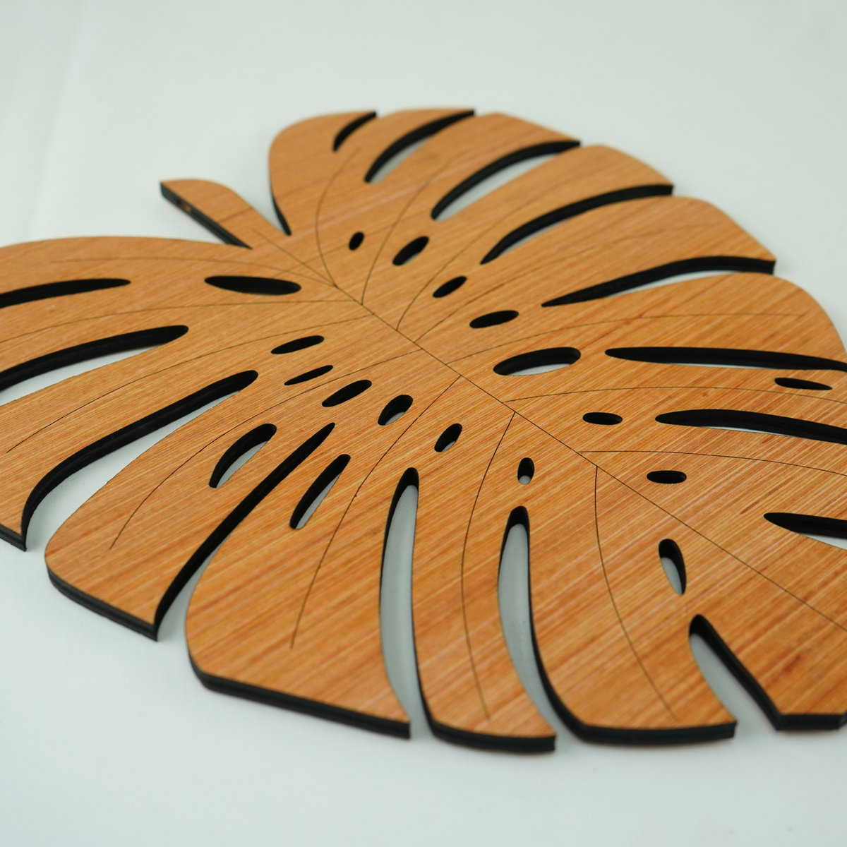A wooden leaf-shaped placemat.