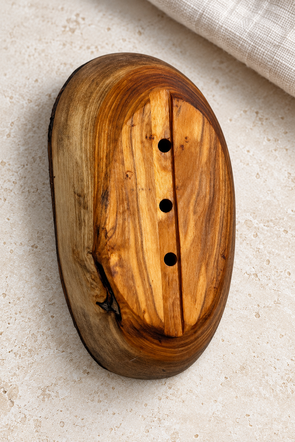 Warm olive wood grain, a rustic bark edge and a simple oval shape bring natural texture to the bathroom basin. This handmade soap dish has three drainage holes and an underside groove