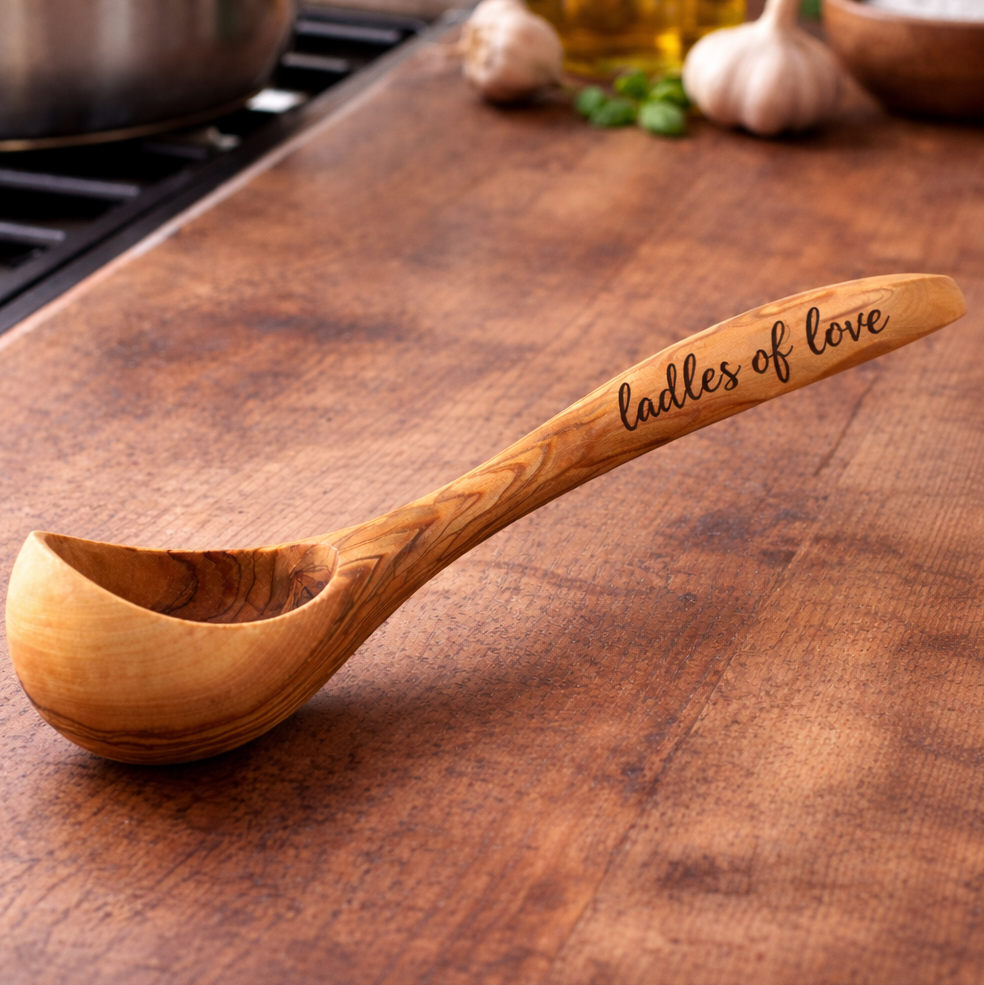 Wooden ladle with 'Ladles of Love' engraving on a wooden surface, with text about personalisation.