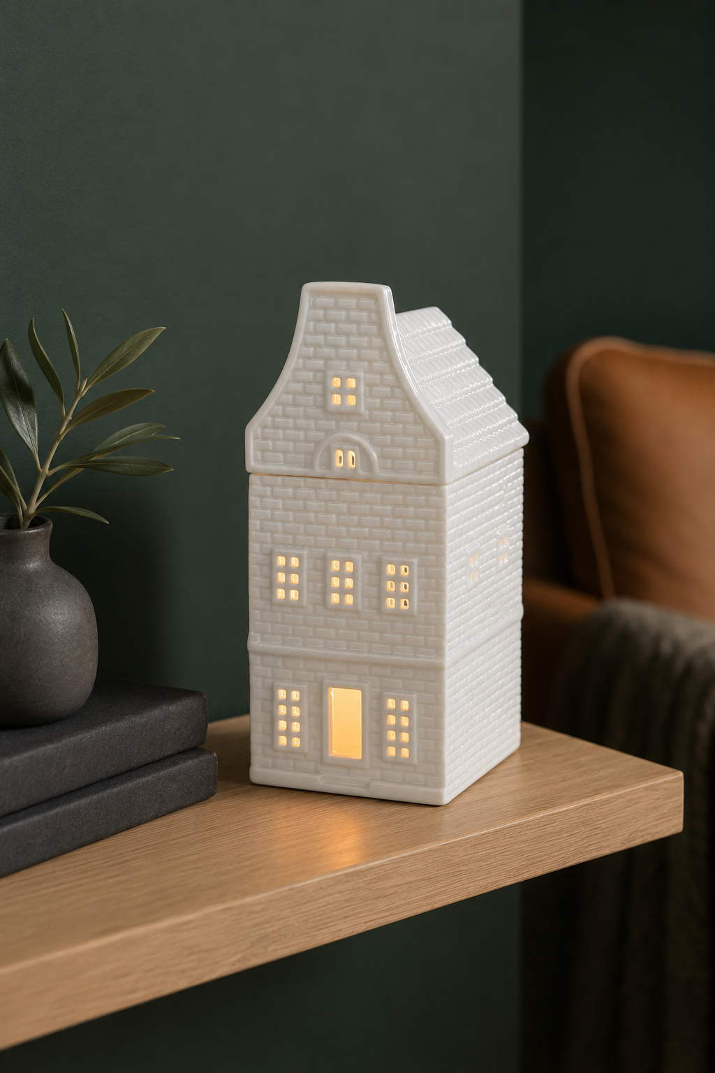 White ceramic Nordic house oil burner and wax warmer with a tall roof and removable top.
