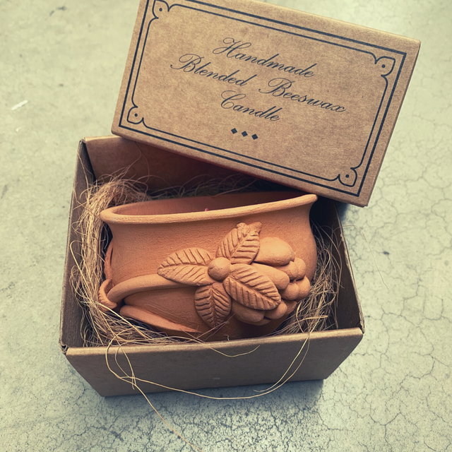 Handmade beeswax candle in a cardboard box with 'Handmade Blended Beeswax Candle' text.