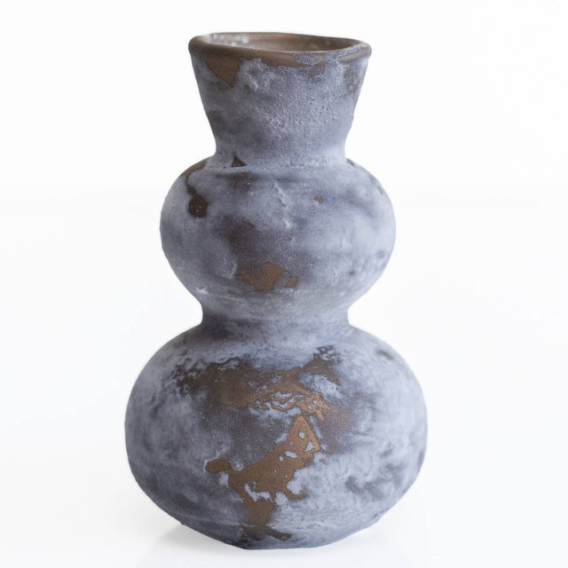 glass vase with a textured surface on a white background