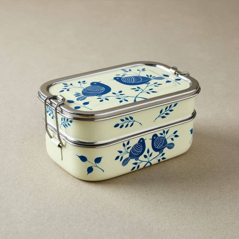 Rectangular tiffin tin food container with blue bird design on a beige background