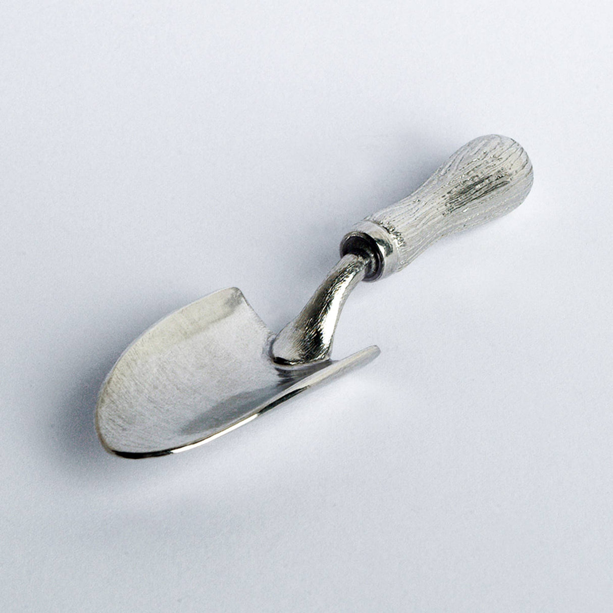 Metal garden trowel with wooden handle on a white background