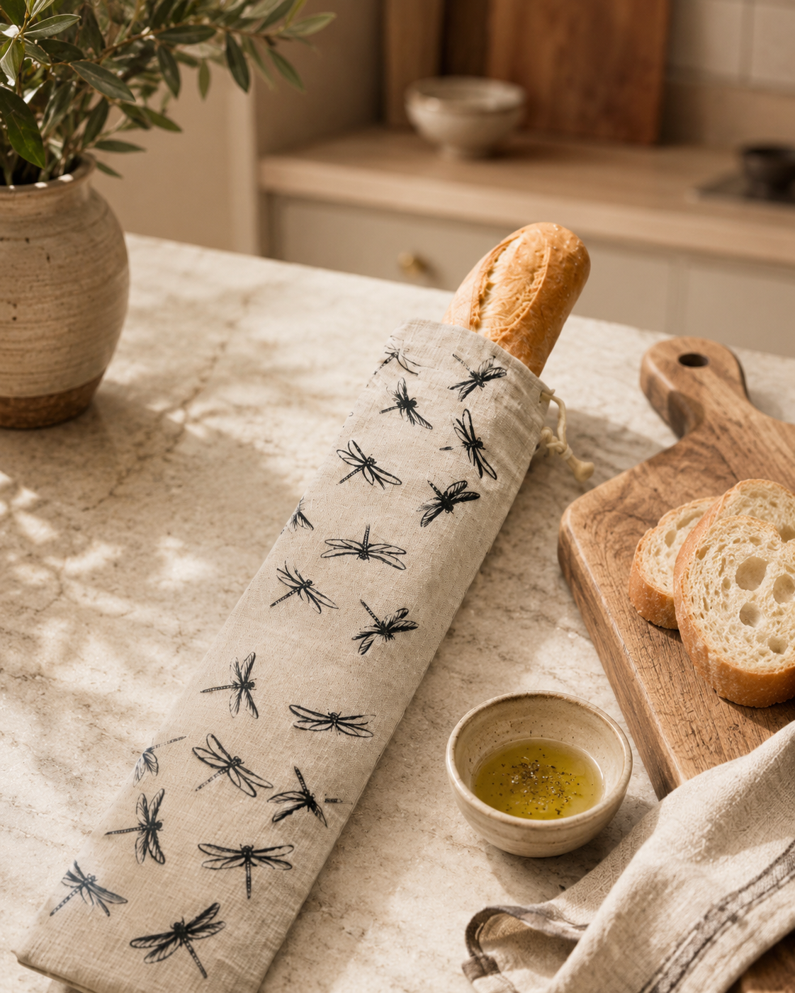 Natural linen baguette bag with an exclusive black Dragonfly design, hand printed and made in Derbyshire. Sized for French sticks, baguettes and longer artisan loaves, with a cotton drawstring, wooden toggle and hanging loop