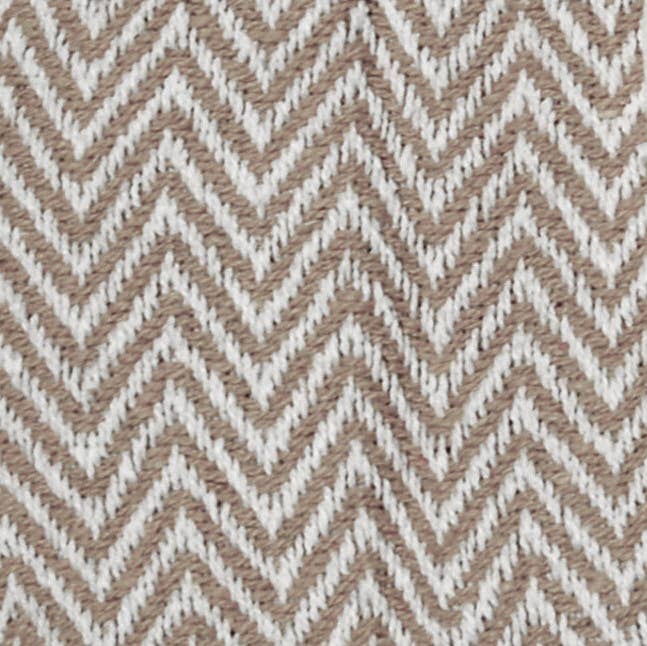 Pattern of brown and white zigzag lines on a textured fabric background