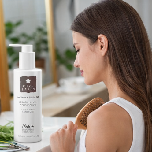 a woman using Pure Lakes hair care products with the product displayed in frame.