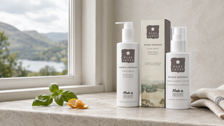 Pure Lakes natural hand wash and hand and body lotion beside a cottage window overlooking the Lake District.