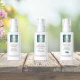 Three bottles of Pure Lakes skincare products on a wooden surface with a blurred natural background.