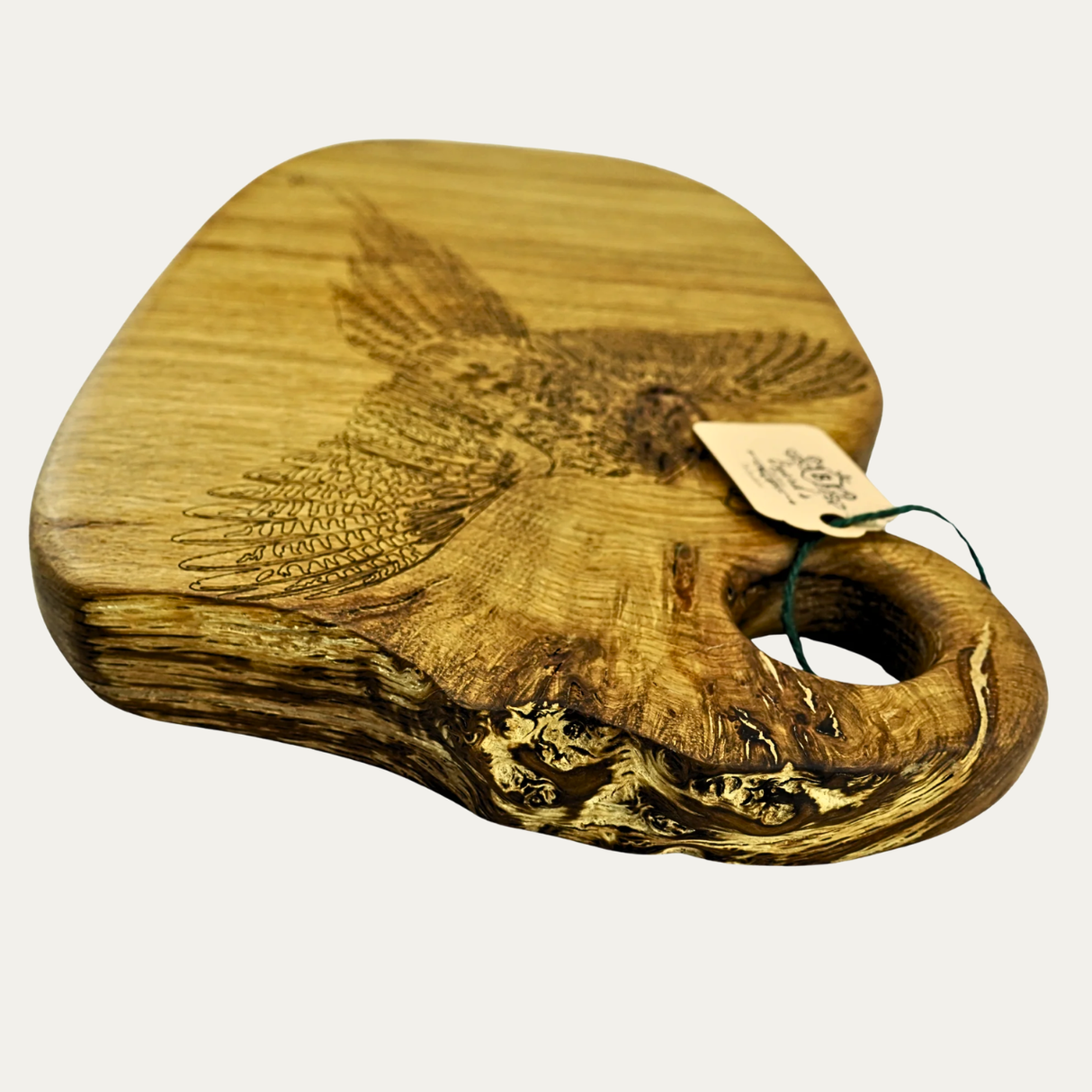 Wooden cutting board with engraved design on a white background