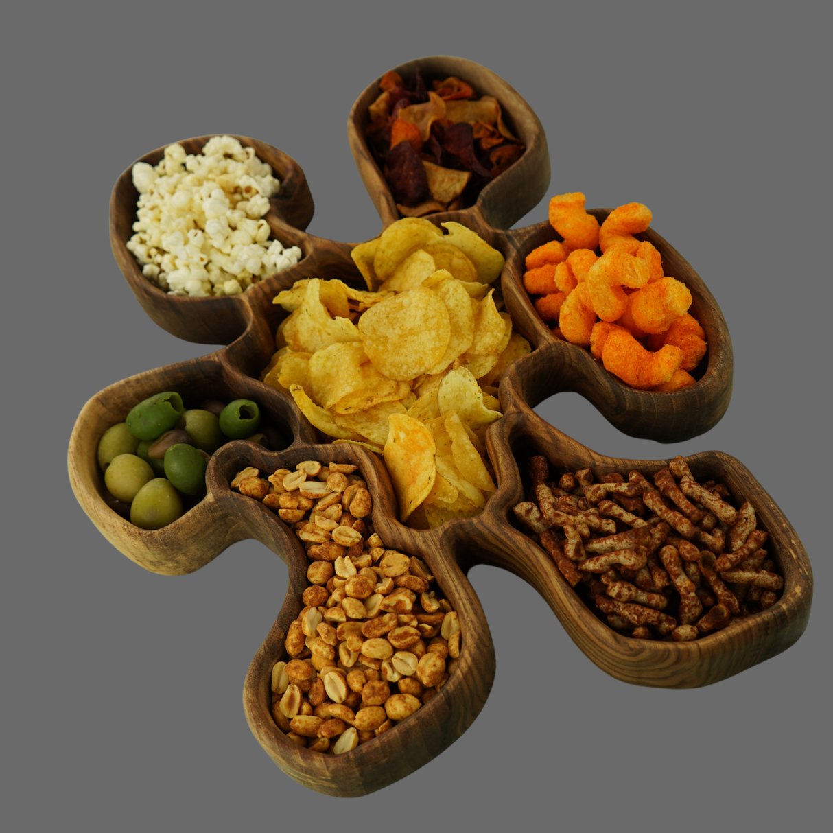 Wooden snack tray with compartments filled with various snacks on a gray background