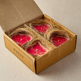 Red candles in a cardboard box with twine, branded 'DAJIT', on a neutral background
