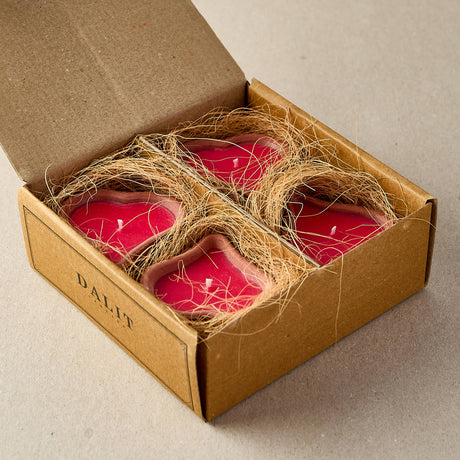 Red candles in a cardboard box with twine, branded 'DAJIT', on a neutral background