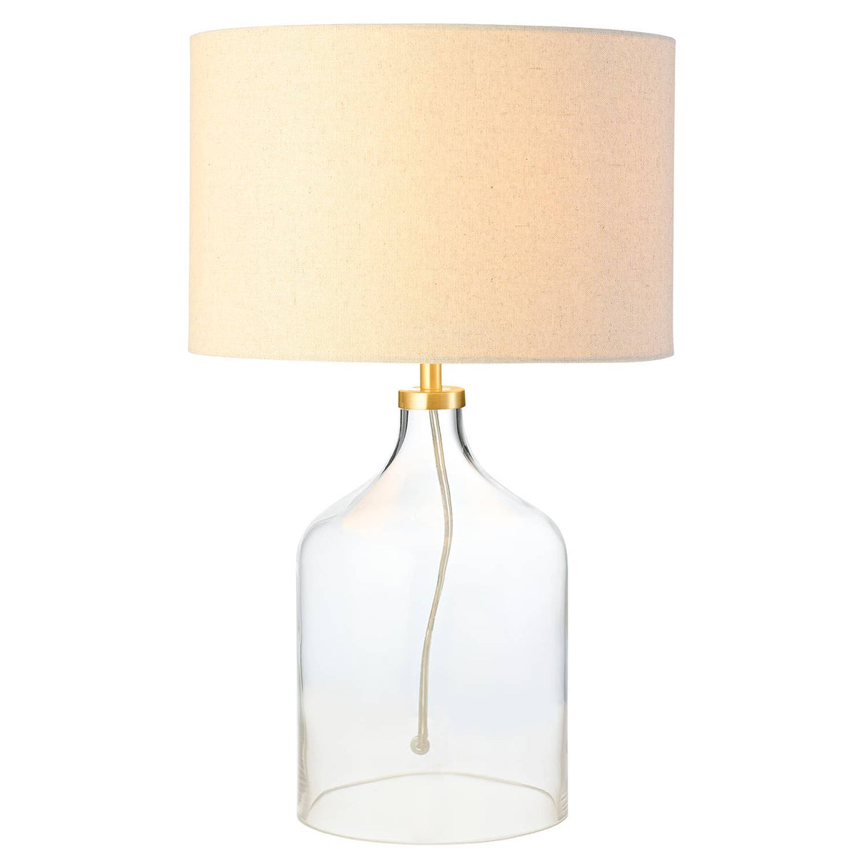 Table lamp with clear glass base and beige fabric shade on a white background