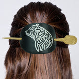 Hair tie with bear design and wooden ends on a person's hair against a white background