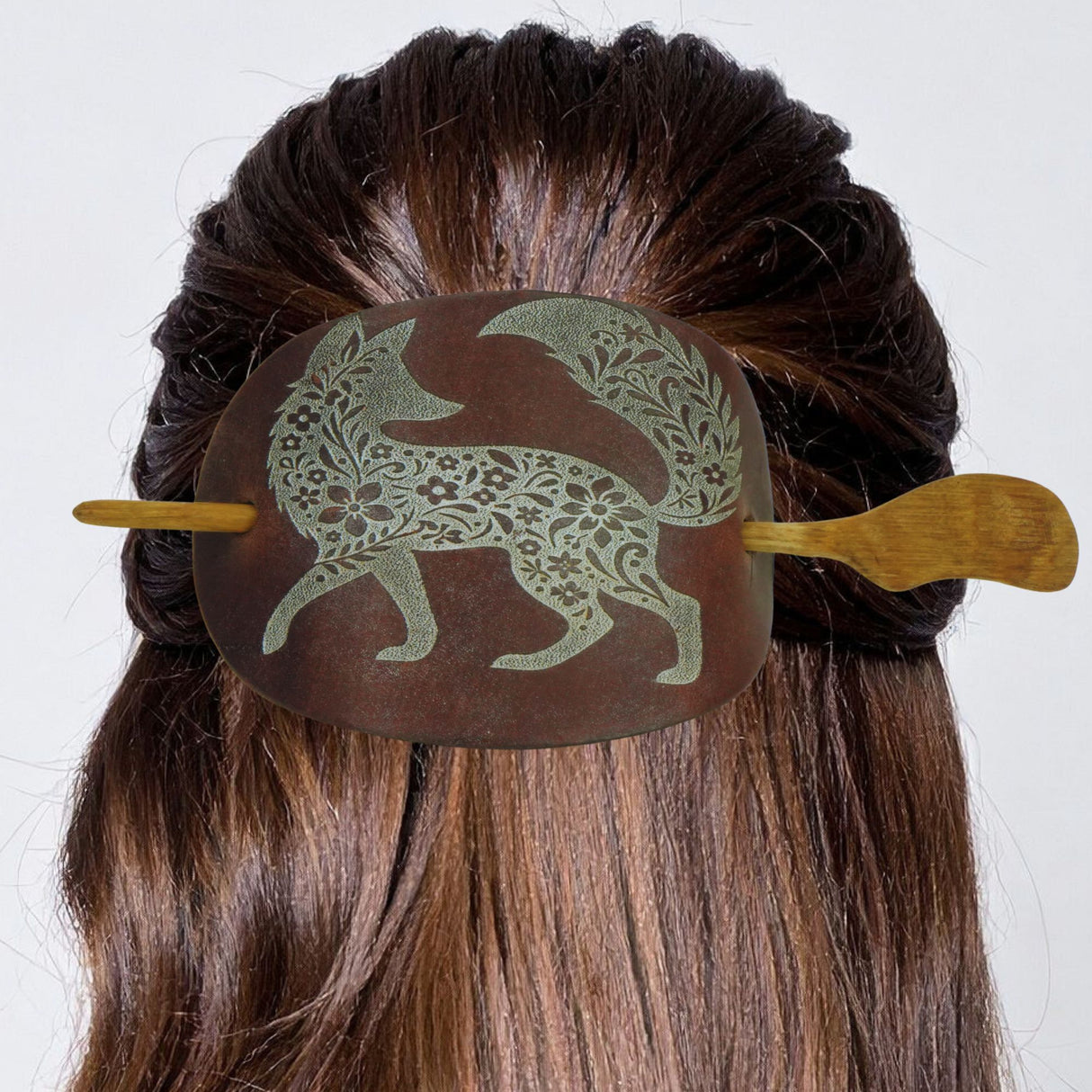 Hair bun with decorative hair clip featuring a fox design on a white background