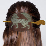 Hair bun with decorative hair clip featuring a fox design on a white background