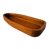 Wooden boat-shaped dish on a white background