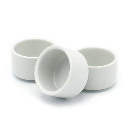 Three white egg cup ceramic bowls on a white background