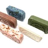 Five different colored soap bars on a white background