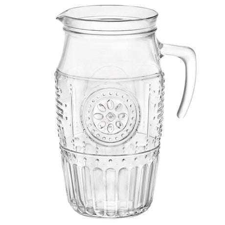 Clear glass pitcher with decorative embossing on a white background